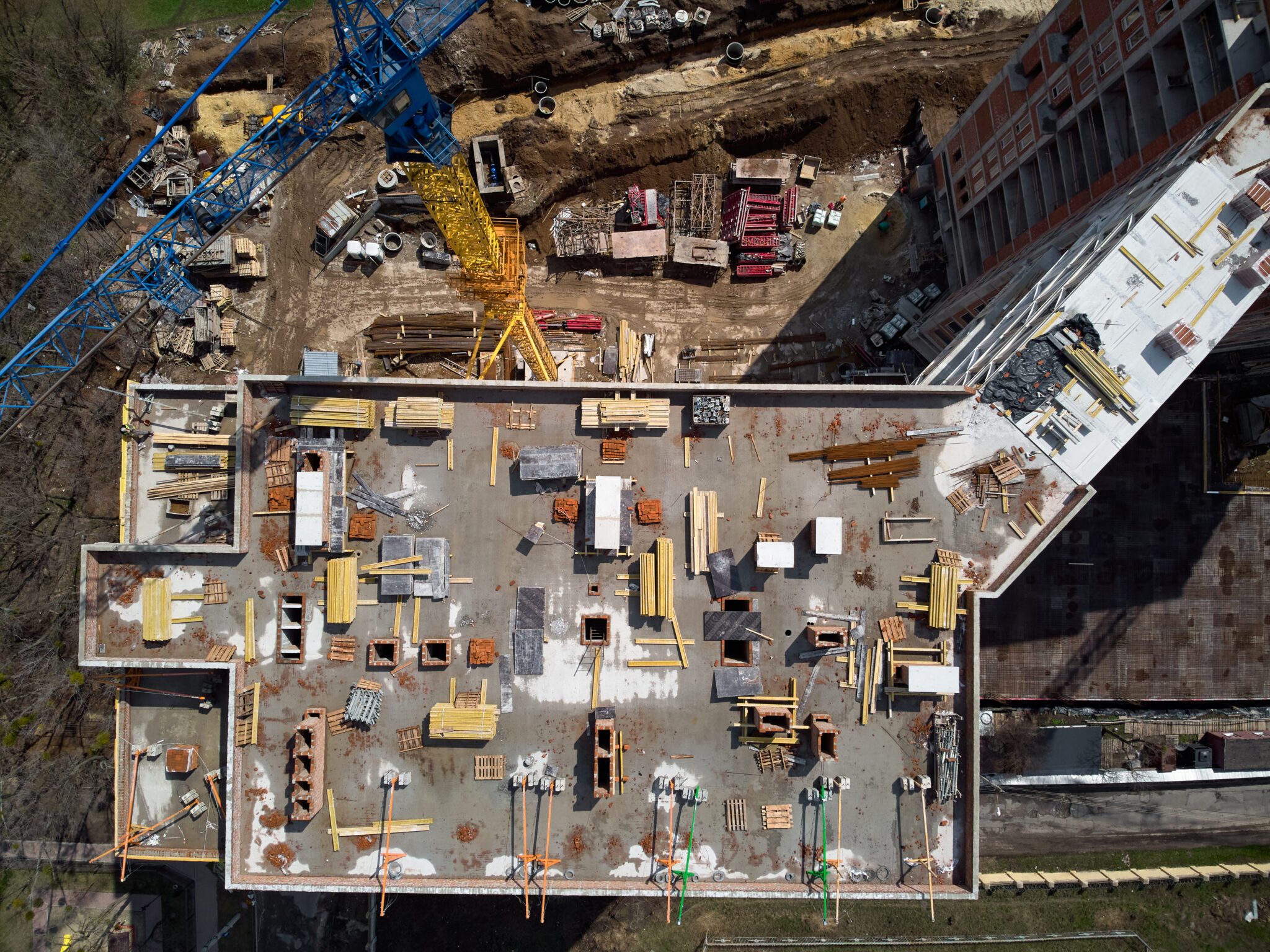 Busy Construction Site and Construction Equipment Aerial Photo top shot