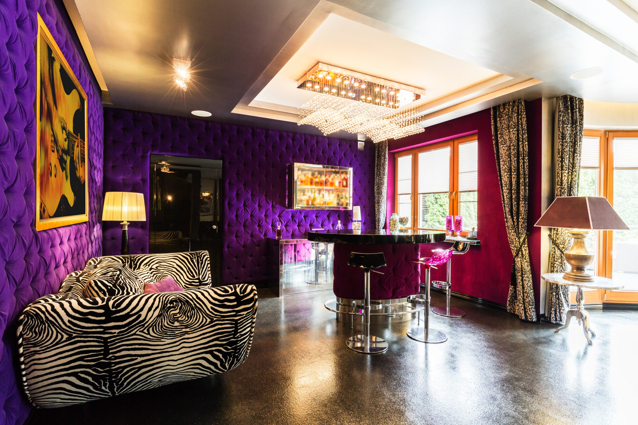 Modern living room with violet upholstered walls, glitter floor, pattern zebra sofa, bar table and stools